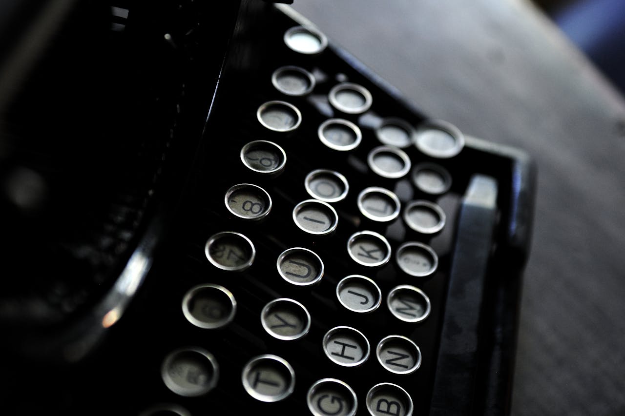 Artistic shot of vintage typewriter keys with a classic black and white contrast.